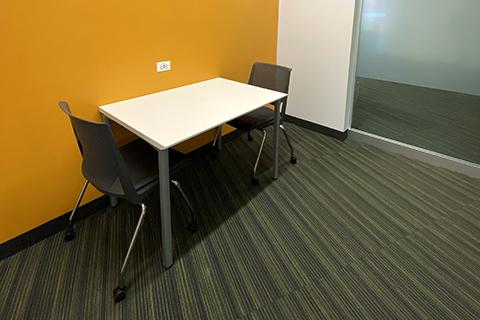Small study cubicle with table, two chairs
