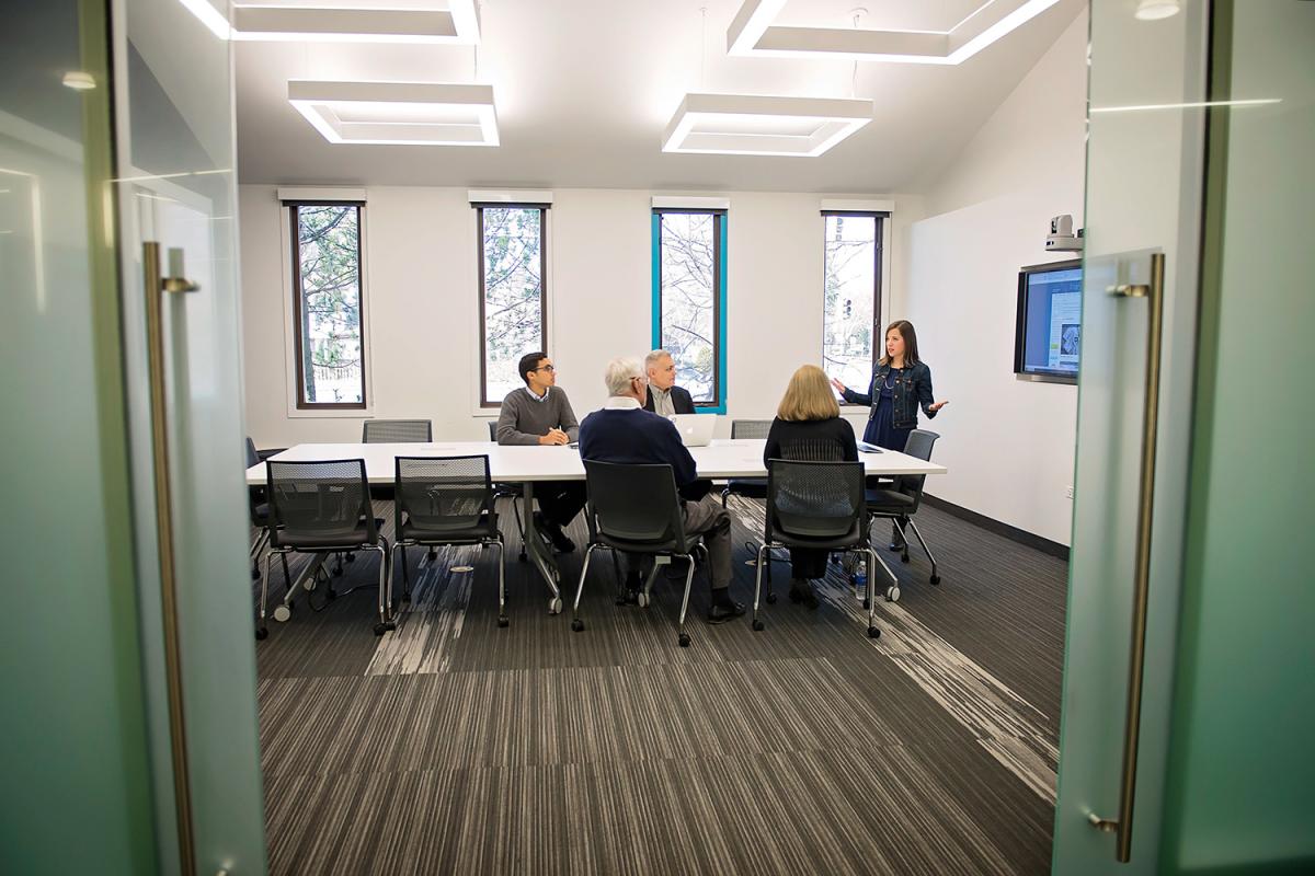 Conference Room interior shot with conference table, chairs and a mounted monitor